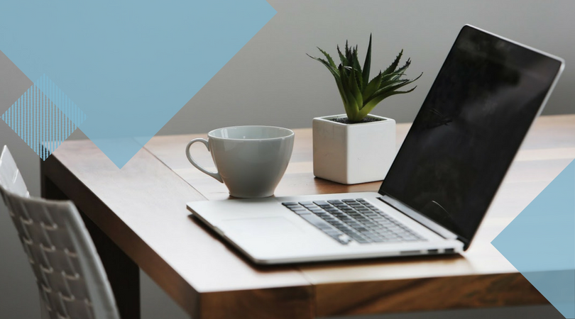 laptop sitting on a wooden table next to a plant and coffee mug with light blue geometric shape overlays