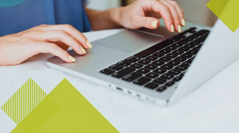 woman with yellow nail polish types at computer with light green geometric overlays