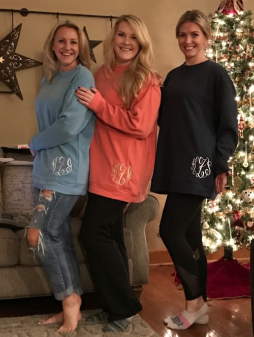 Kami and sisters posing in monogrammed sweaters at christmas
