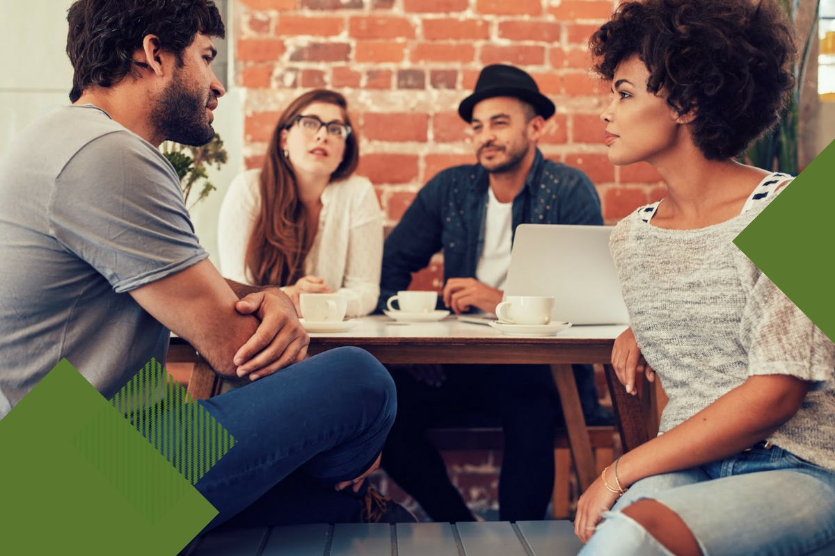 group of young friends sitting around a table talking with dark green geometric shapes around boarder of photo