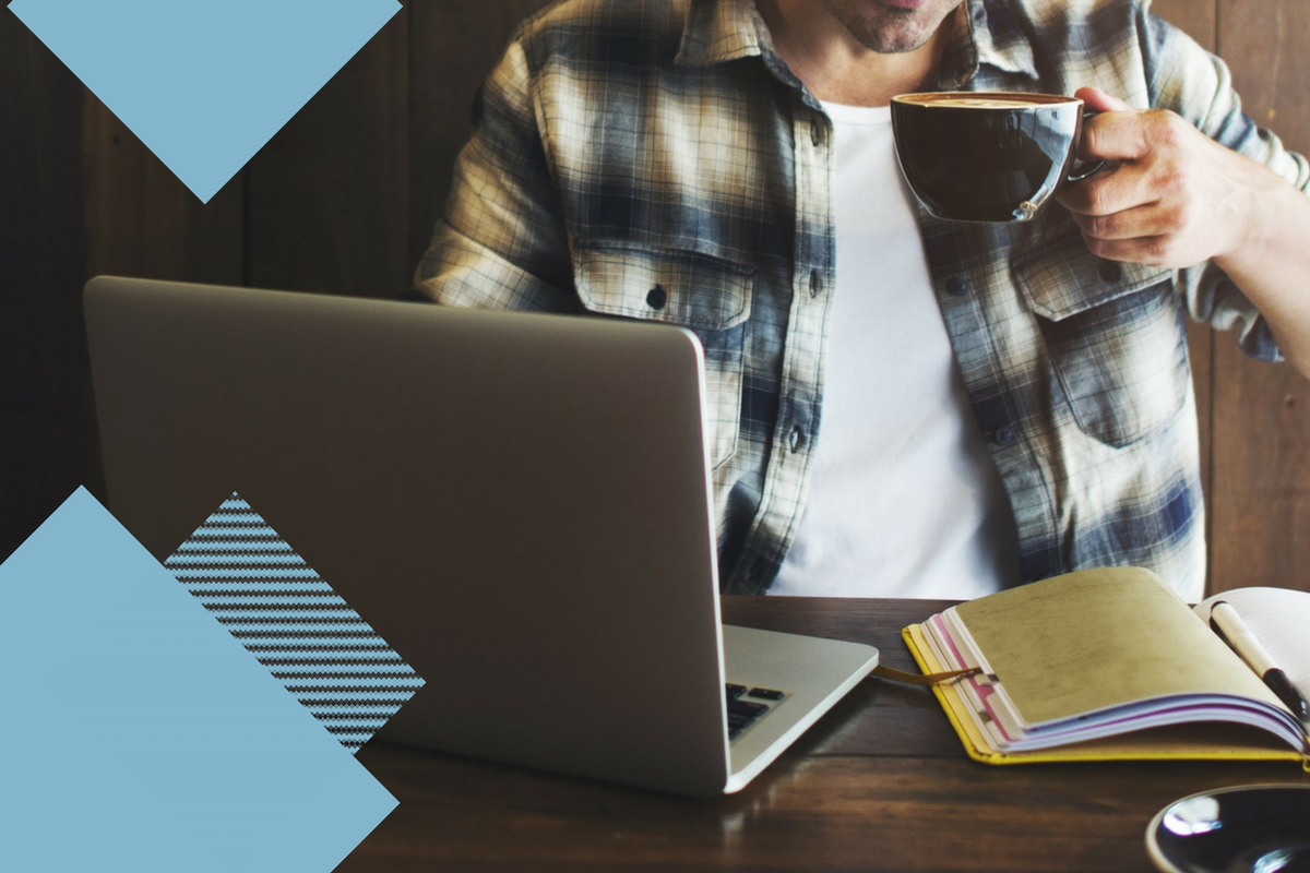 man drinking coffee at computer