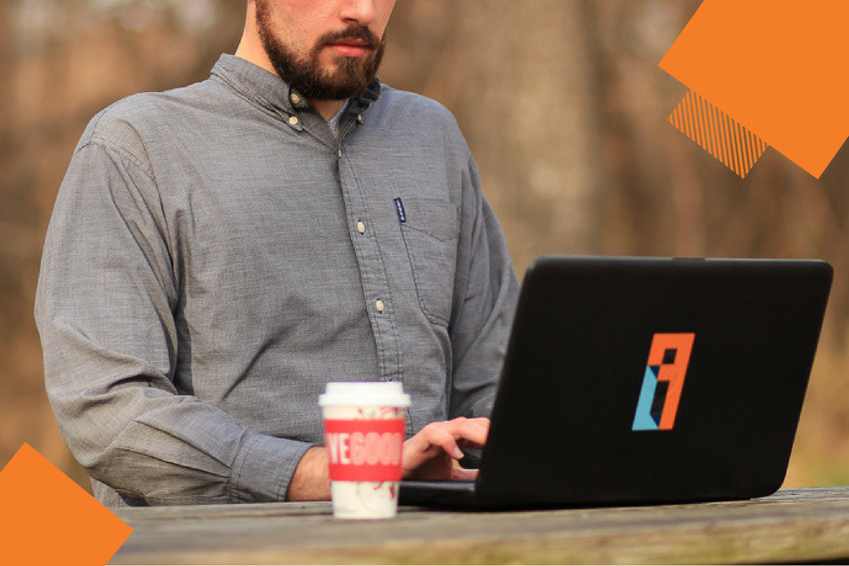 man sits and works on laptop