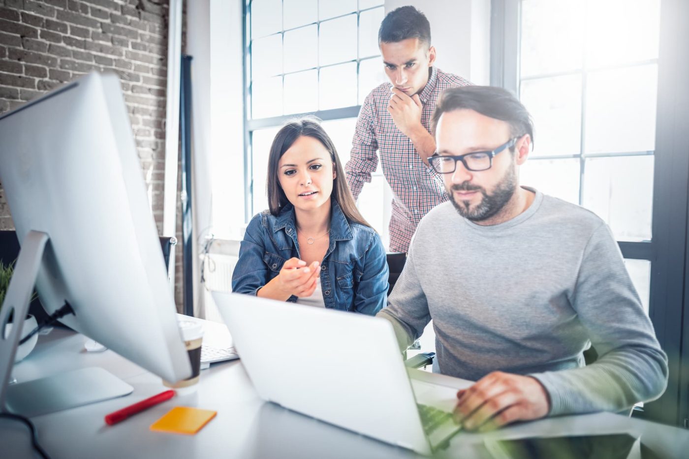 team of people looking at computer