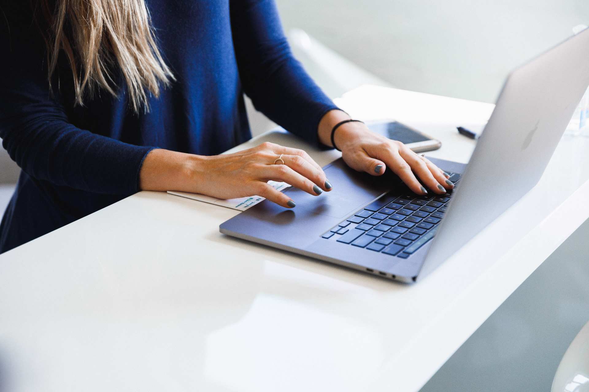 a woman is typing on a computer