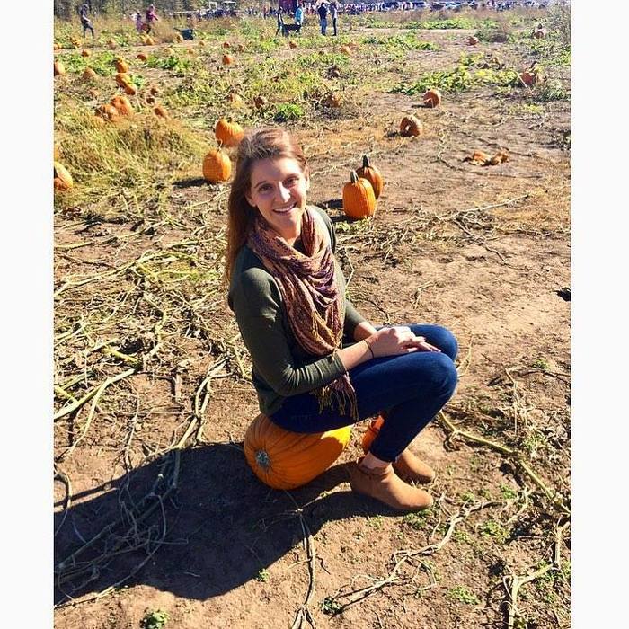 Kim G sitting on a pumpkin