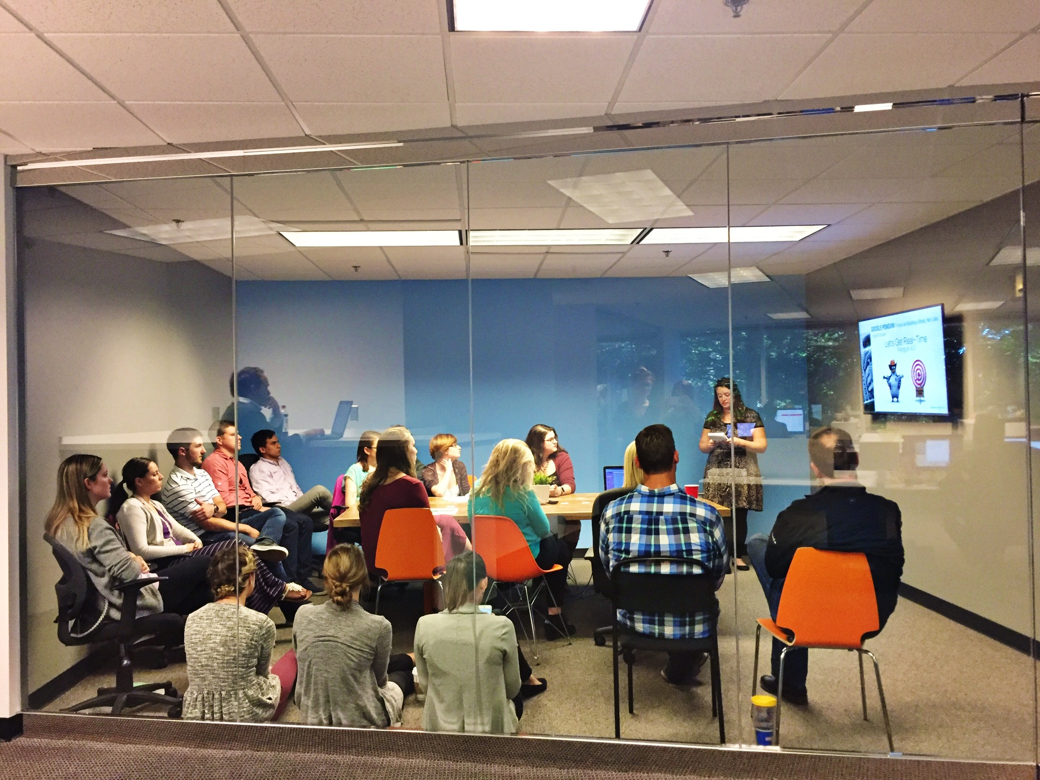 employees of Go Local gather in glass conference room