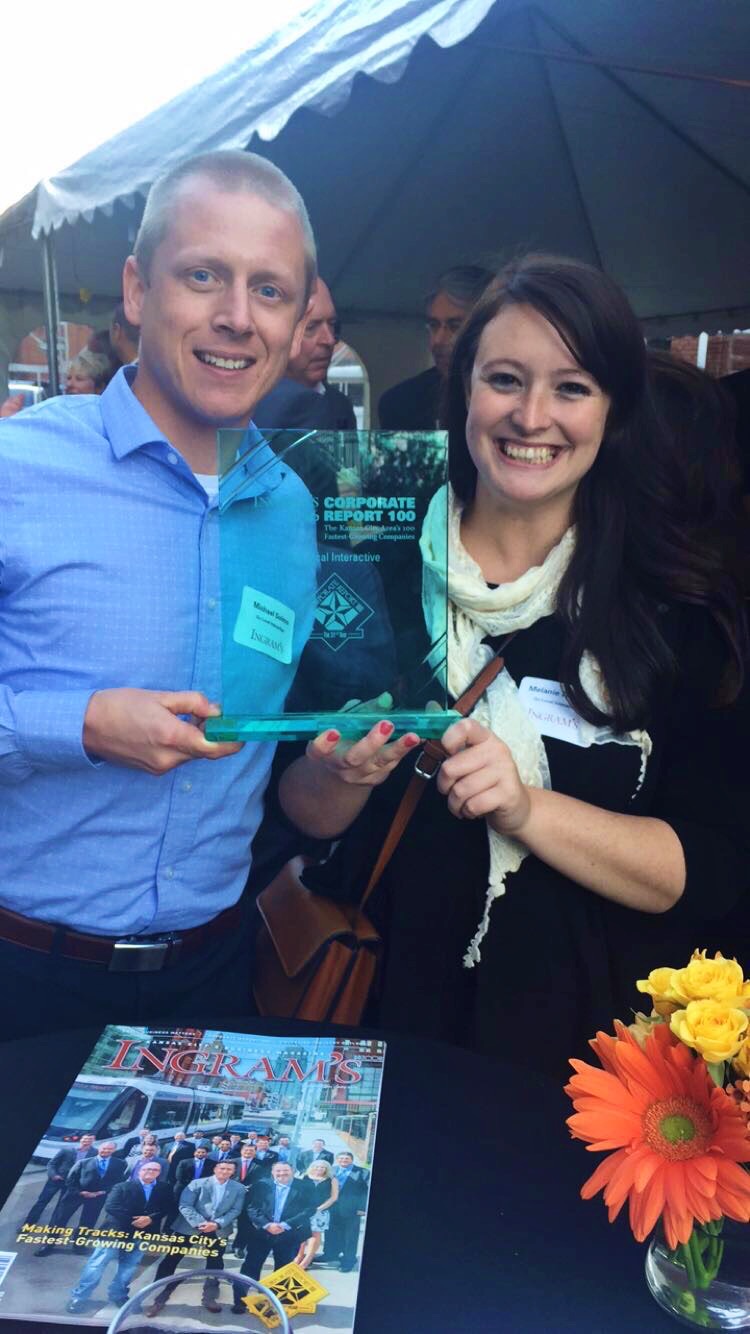 Michael S and Melanie T holding Ingram's award