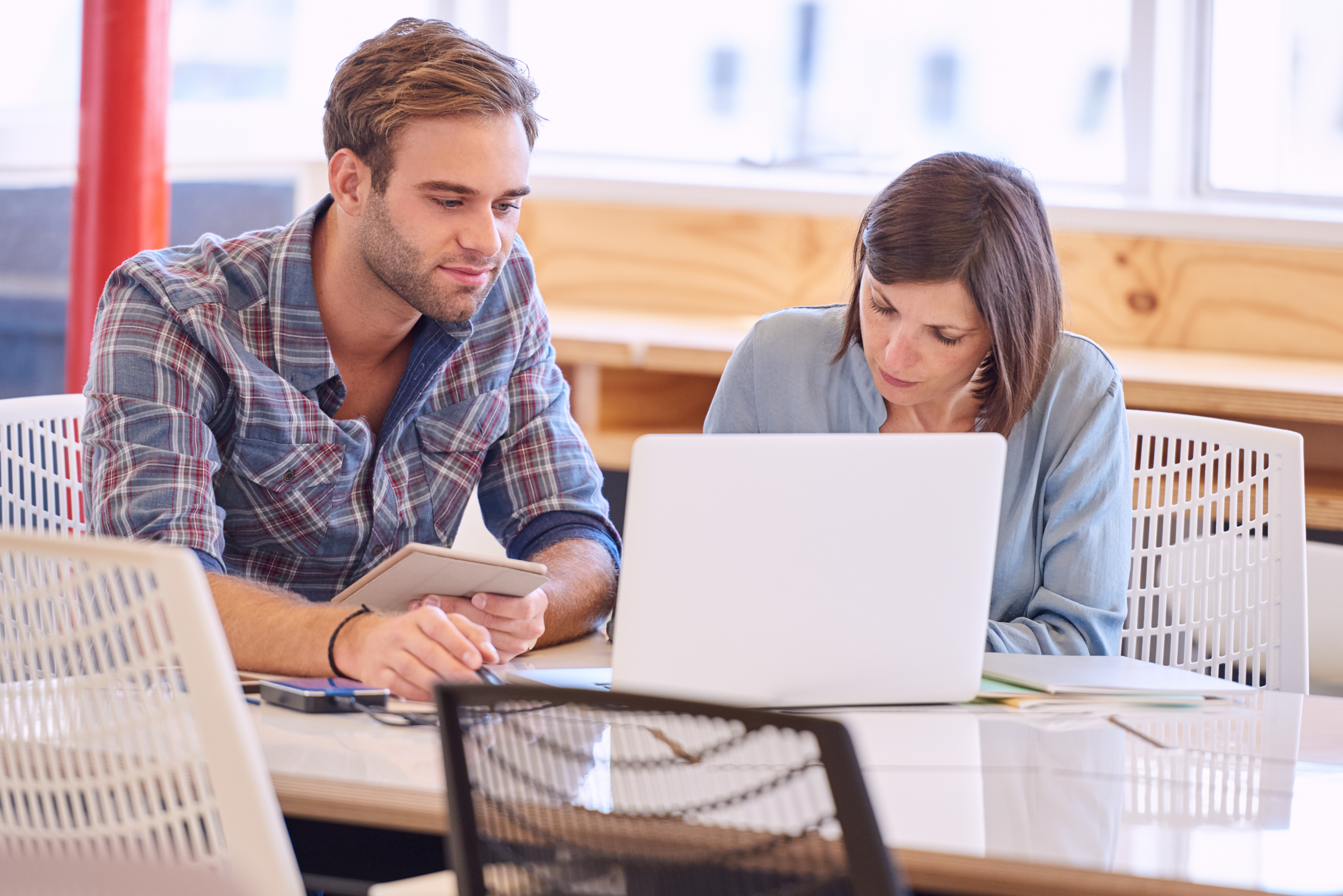 man and woman working on a laptop