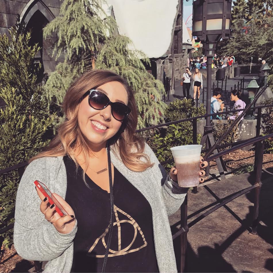 Ashley drinking butterbeer at Harry Potter World