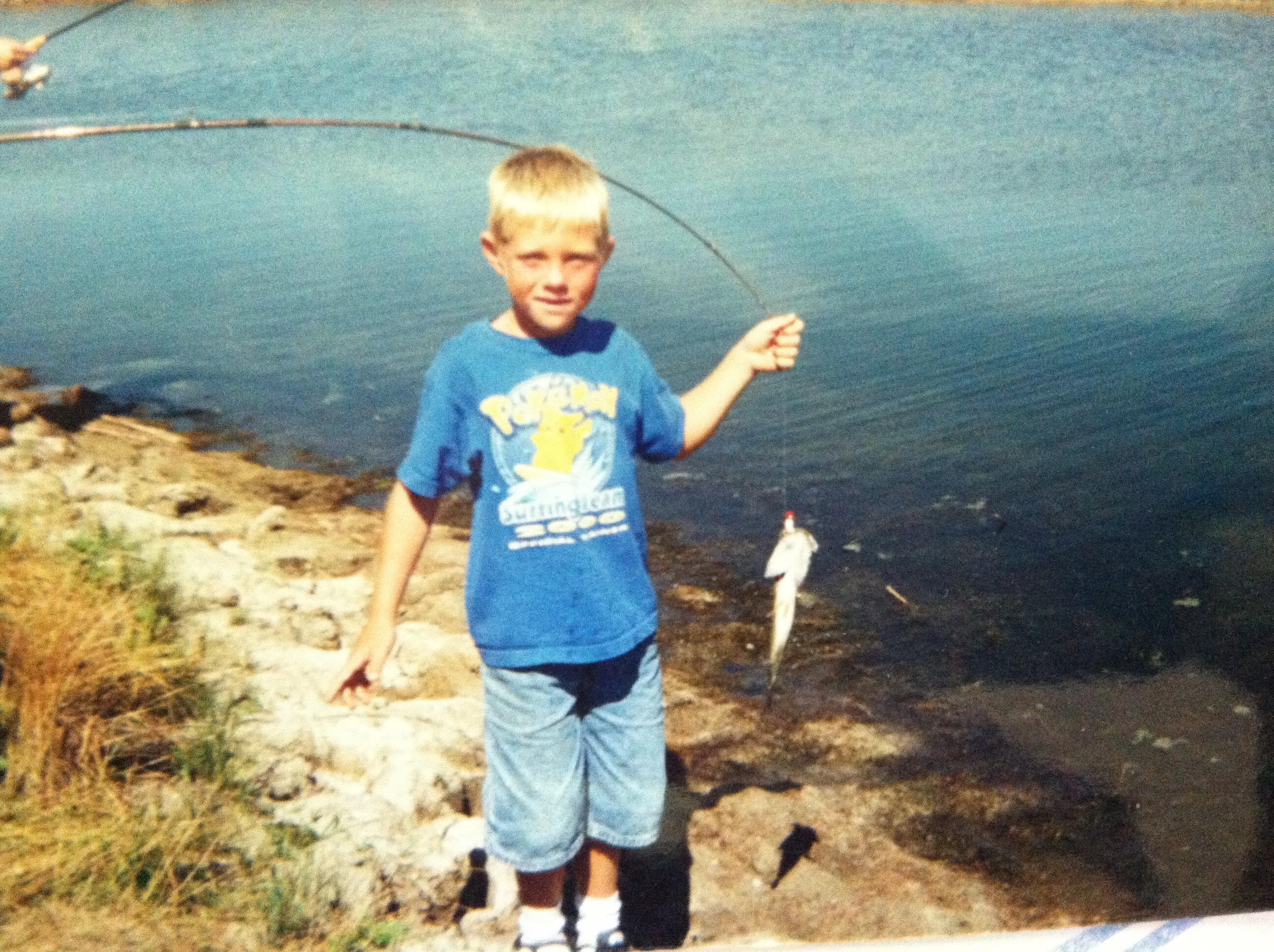 Chris Garten with fish at lake